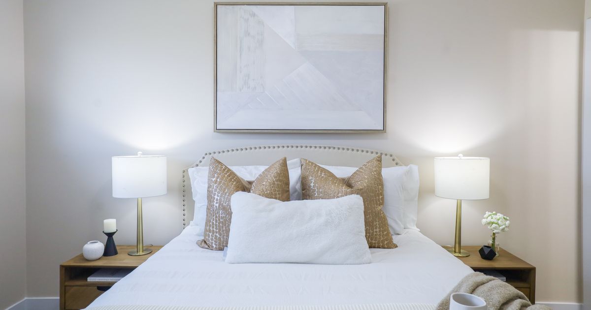 Cozy bedroom interior featuring modern decor and neutral color palette for home staging.