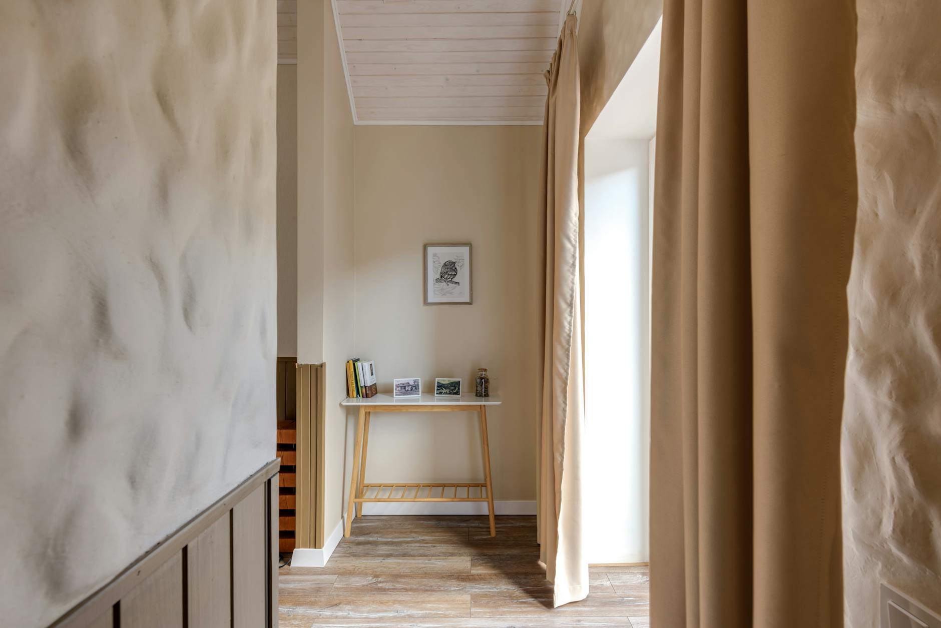 Stylish hallway with minimalist decor, wood floor, and soft lighting