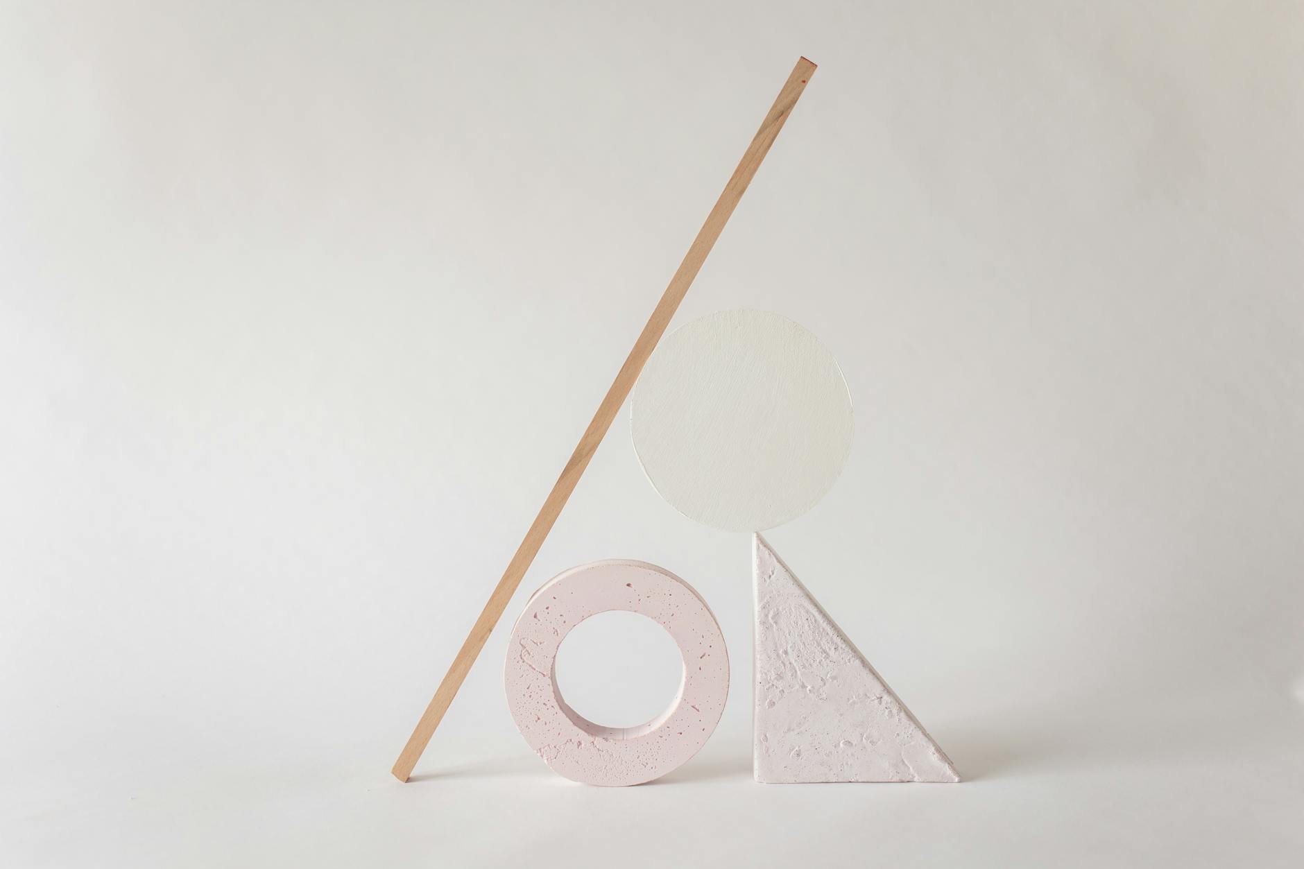 Elegant minimalist arrangement of abstract geometric shapes on a light neutral background