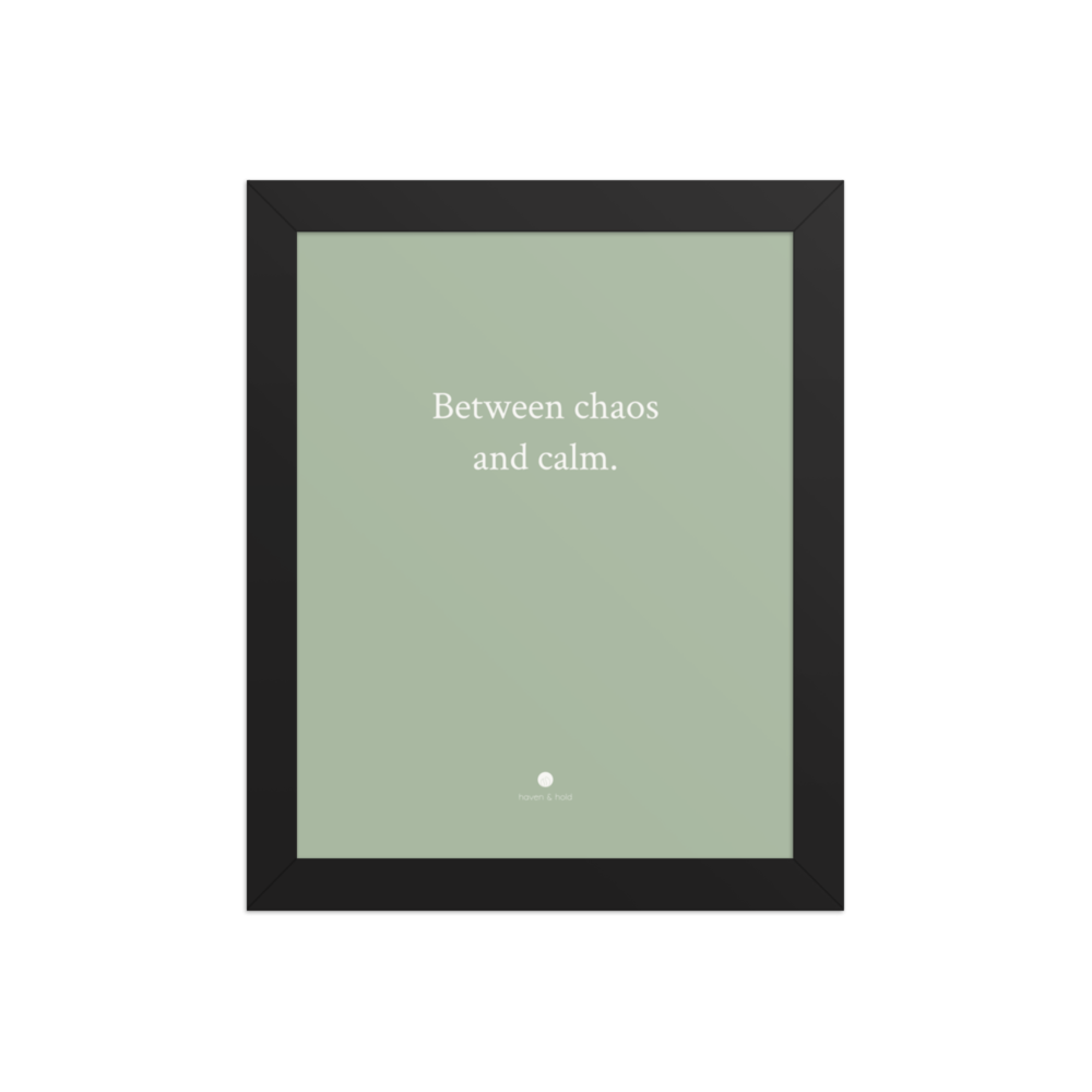 Between Chaos And Calm framed typography print in black frame, studio product view