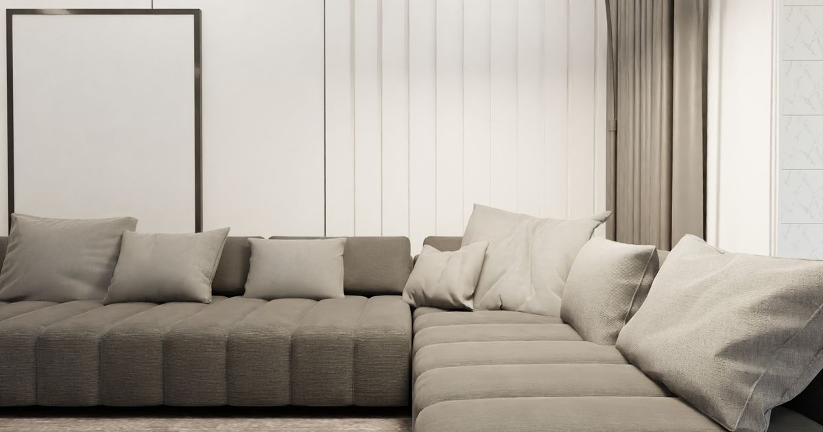 Elegant Scandinavian living room featuring a minimalist design with a stylish, gray sectional sofa and plush cushions.