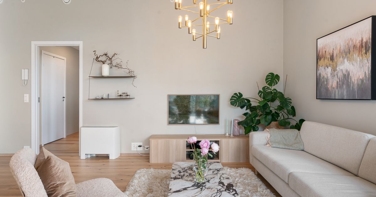 Elegant living room featuring minimalist design, plush furniture, and stylish lighting.