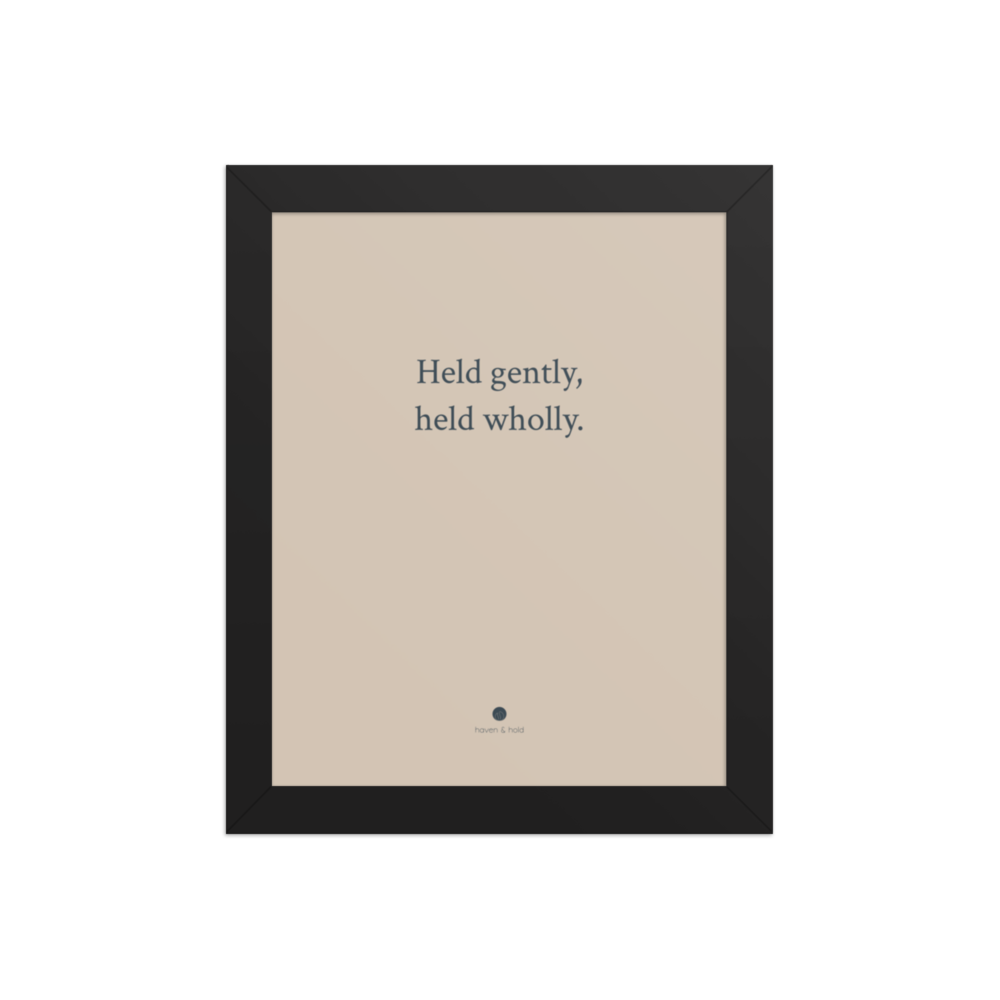 Held Gently Held Wholly framed typography print in black frame, studio product view